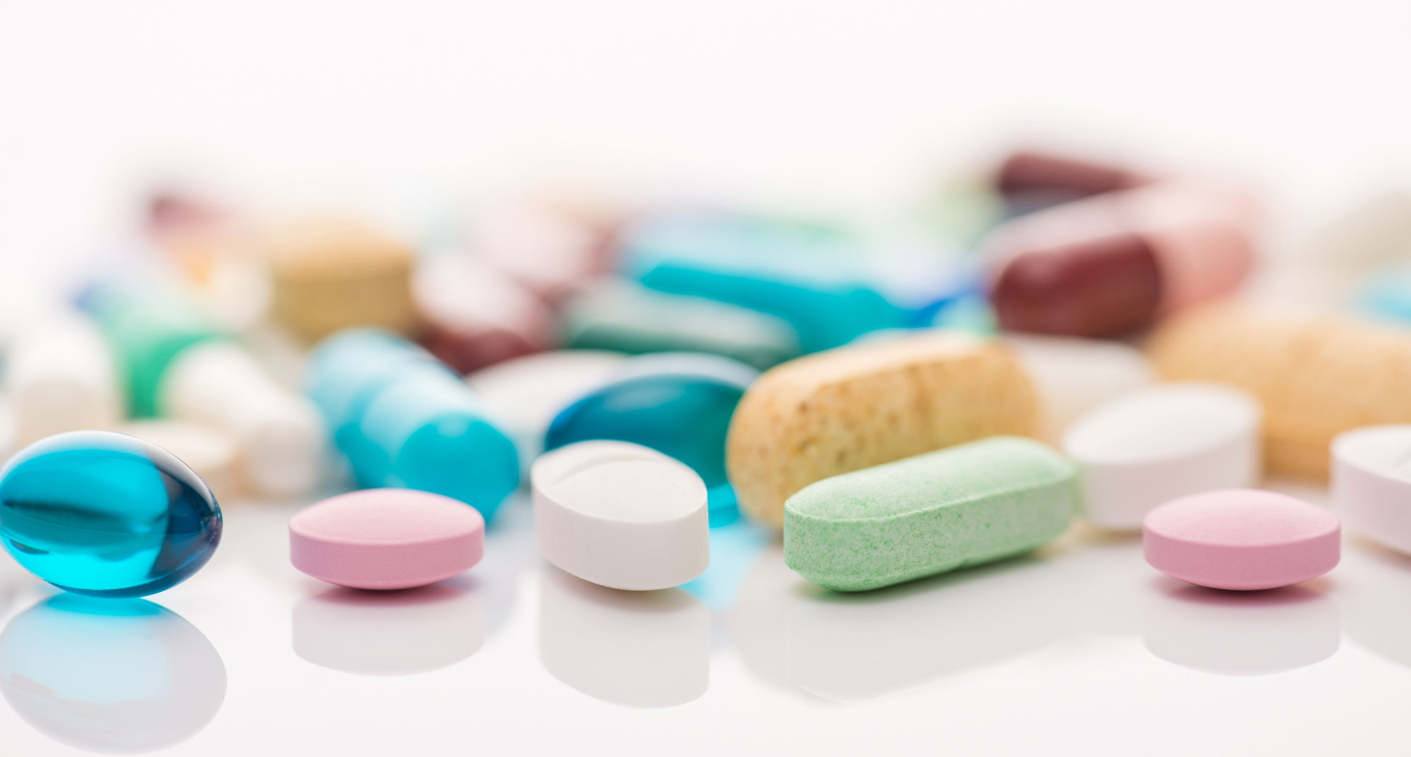 multicolored pills on white table