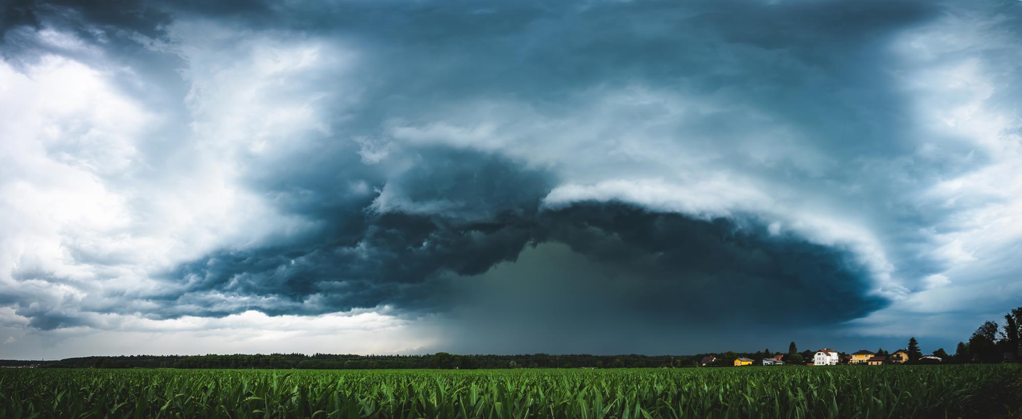 dark thunderstorm over cornfield.